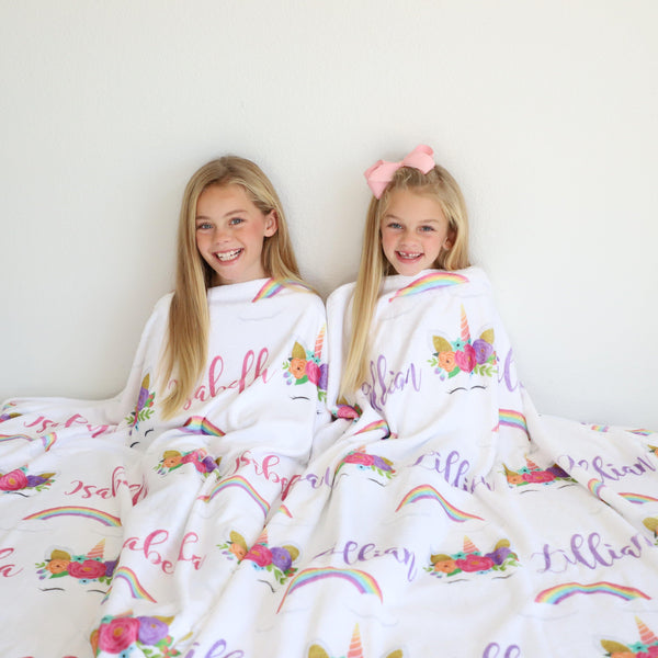 Stunning sisters on their Rainbow and Unicorn blankets!  A favorite for young girls!
